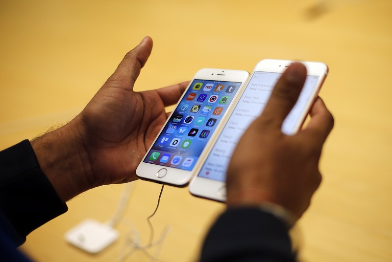FILE - In this Friday, Sept. 25, 2015, file photo, a customer tries out a new Apple iPhone 6S at an Apple store in Chicago. The FBI now says that it may have a way to crack into an iPhone used by one of the San Bernardino shooters, despite previous claims that it could only achieve that with Apples help, but it remains unclear exactly how it plans to do that. (AP Photo/Kiichiro Sato, File)