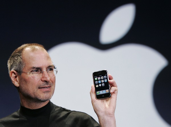 FILE- In this Jan. 9, 2007, file photo, Apple CEO Steve Jobs holds up an iPhone at the MacWorld Conference in San Francisco. Jobs introduced the first iPhone a decade ago. Jobs' "magical product" reshaped culture, shook up industries and made it seem possible to do just about anything with a few taps on a screen while walking around with the equivalent of a computer in our pocket. (AP Photo/Paul Sakuma, File)